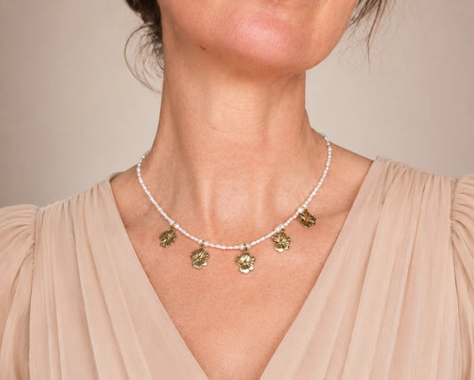 tiny pearl beaded necklace with gold daisy drop pendants