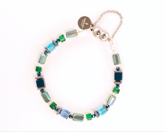 Multicolored beaded bracelet with a silver clasp on a white background