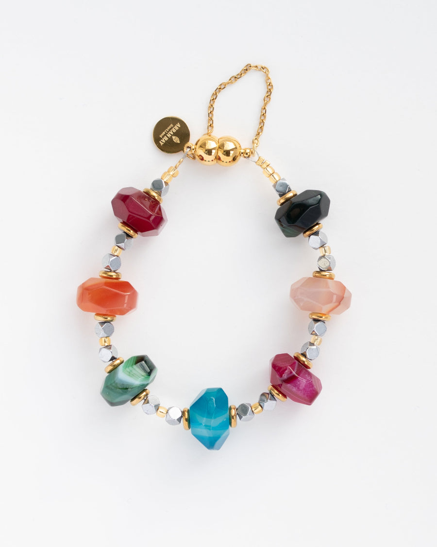 Multicolored beaded bracelet with gold accents on a white background