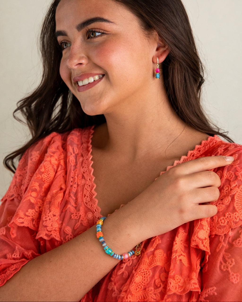 Woman wearing colourful gemstone jewellery